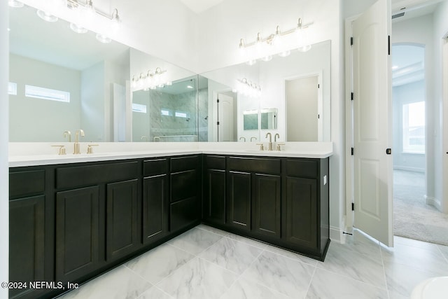 bathroom with vanity and tiled shower