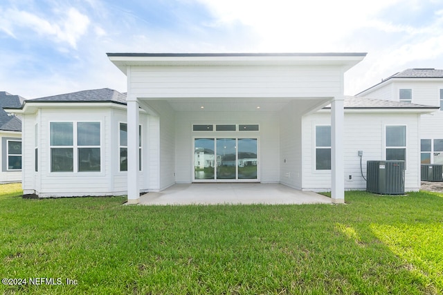 rear view of house featuring a yard, a patio, and cooling unit