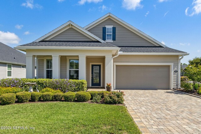 view of front facade with a garage and a front lawn