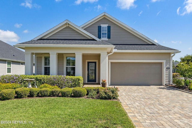 view of front of property with a garage and a front lawn