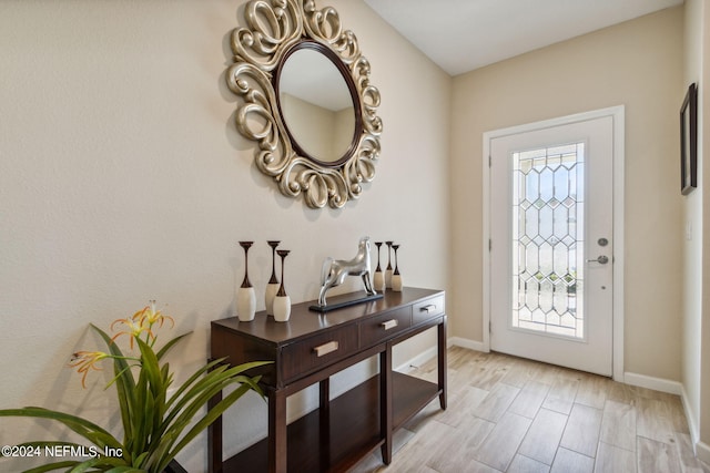 entrance foyer with plenty of natural light and light hardwood / wood-style flooring