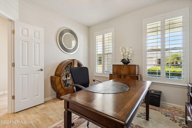 home office featuring a healthy amount of sunlight and light hardwood / wood-style floors