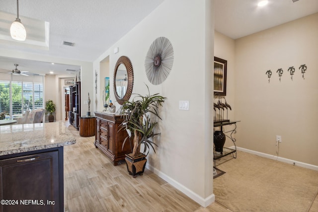 corridor with light hardwood / wood-style flooring