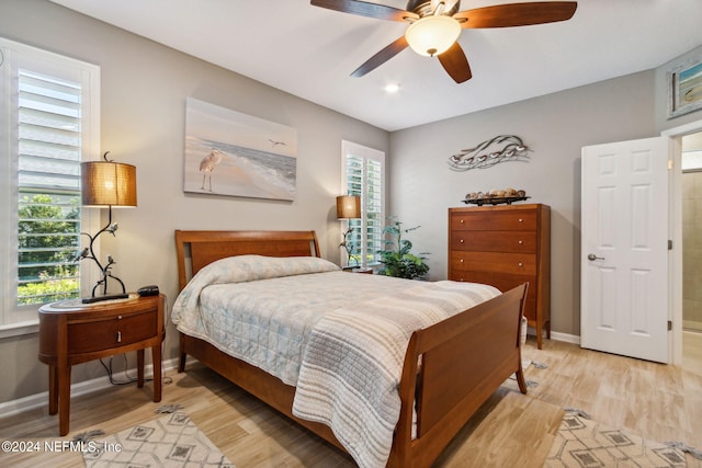 bedroom with light hardwood / wood-style floors and ceiling fan