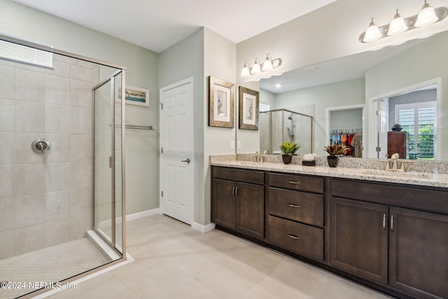 bathroom featuring double vanity, tile patterned floors, and an enclosed shower