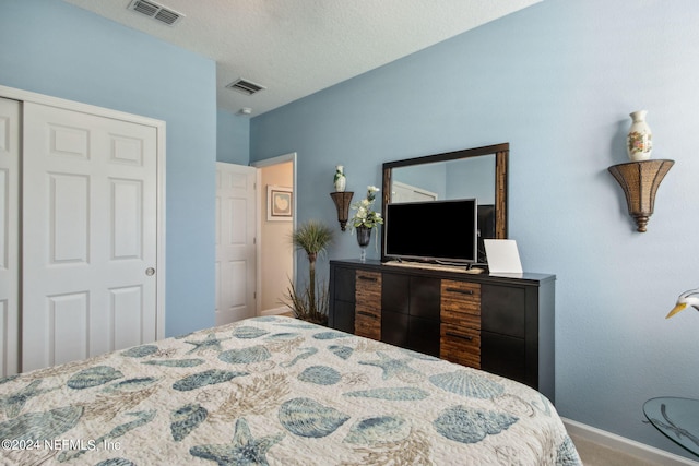 bedroom featuring a closet and a textured ceiling