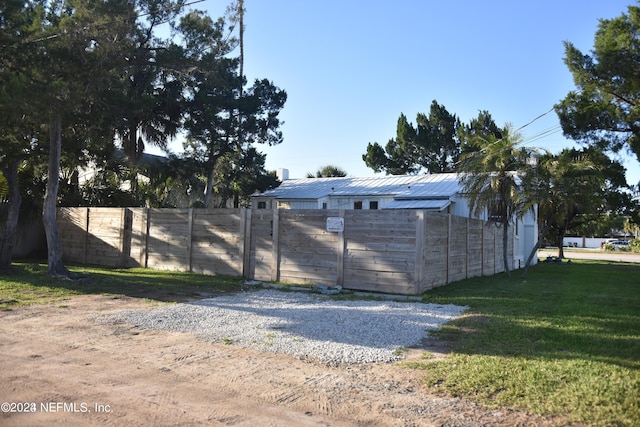 exterior space with fence and a yard