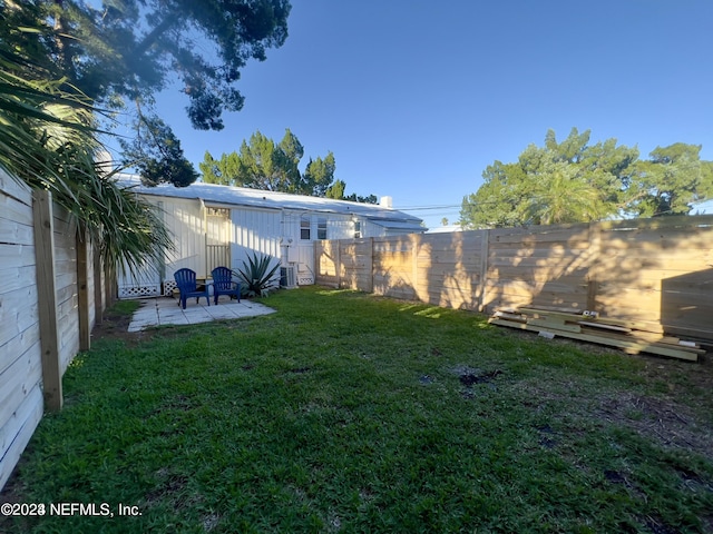 view of yard featuring a patio, cooling unit, and a fenced backyard