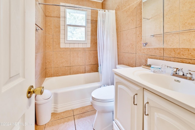 full bathroom with vanity, shower / tub combo with curtain, tile walls, tile patterned flooring, and toilet