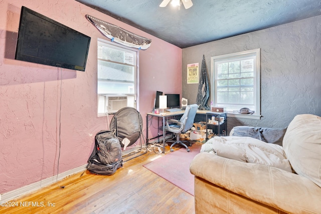 office with ceiling fan, cooling unit, and wood-type flooring