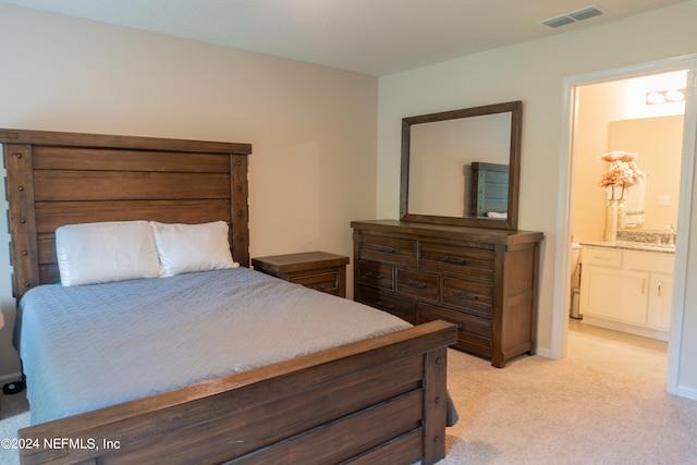 carpeted bedroom with ensuite bath