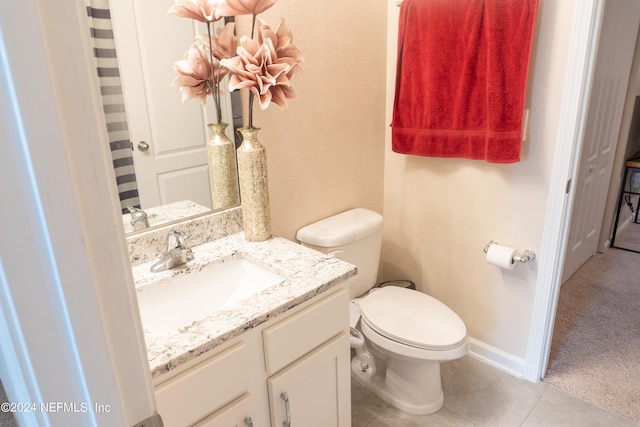 bathroom with vanity, tile patterned flooring, and toilet