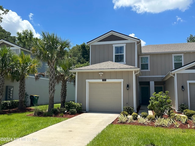 view of front of property featuring a garage and a front lawn