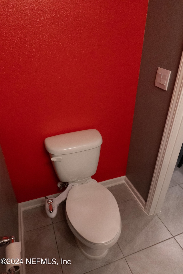 bathroom featuring toilet and tile patterned flooring