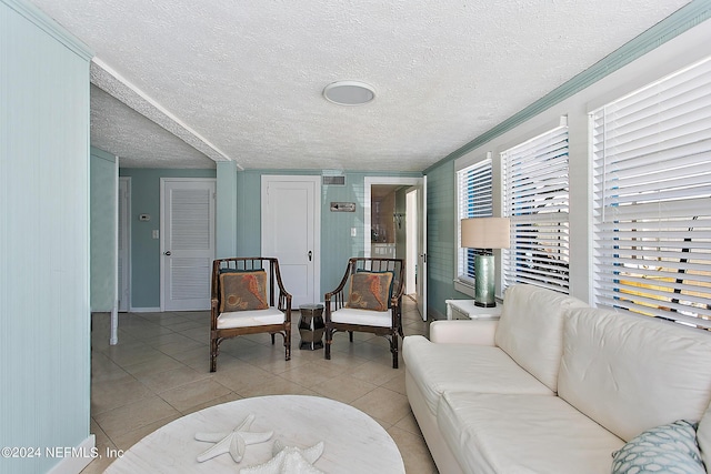 living room featuring a textured ceiling and light tile patterned floors