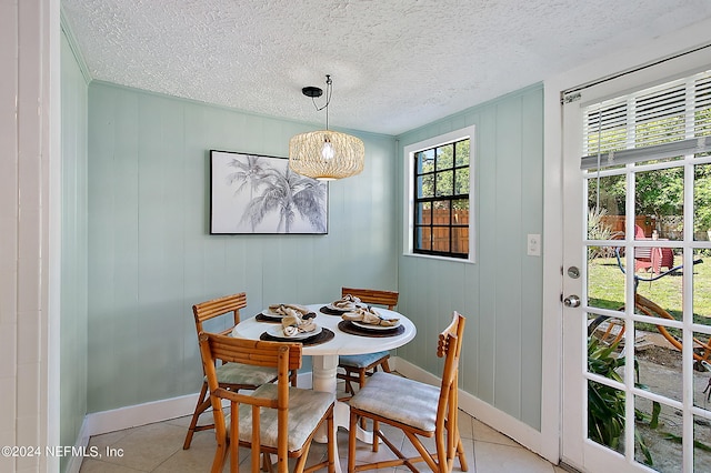 dining room featuring light tile patterned flooring and a textured ceiling