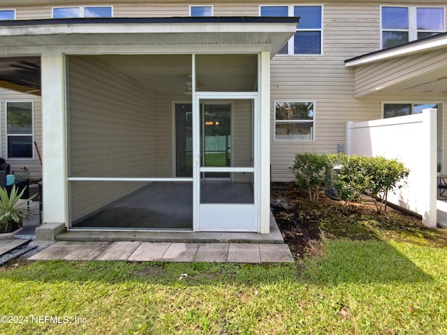 property entrance featuring a lawn