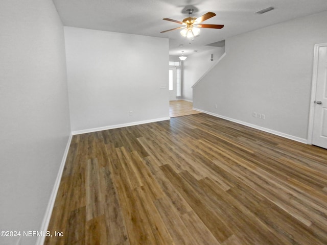 unfurnished living room featuring ceiling fan and dark hardwood / wood-style floors