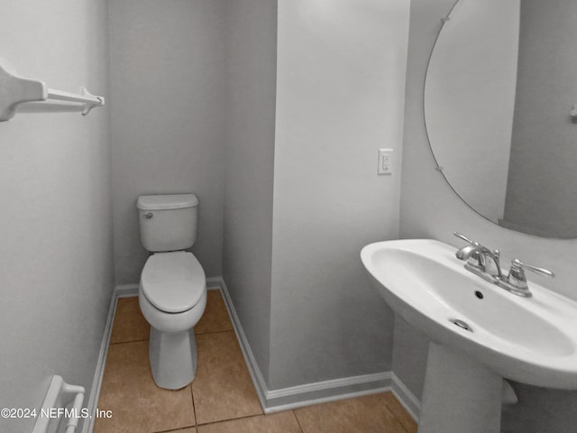 bathroom featuring tile patterned flooring, sink, and toilet