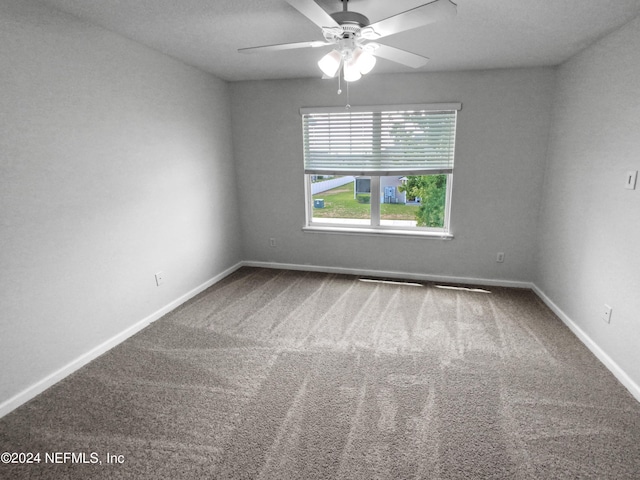 unfurnished room with ceiling fan and carpet flooring