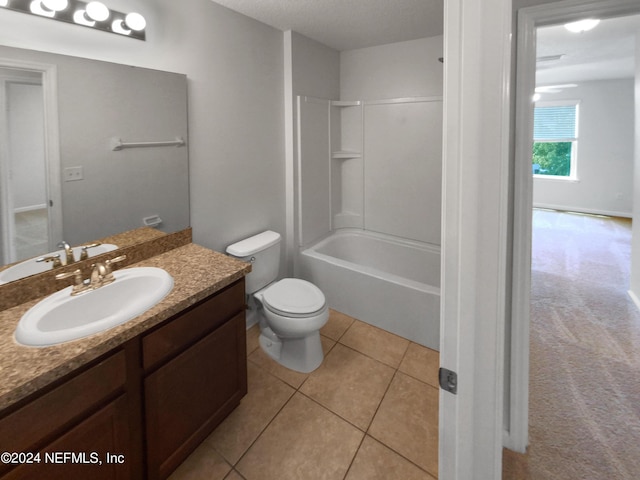 full bathroom with shower / bathing tub combination, vanity, toilet, tile patterned floors, and a textured ceiling