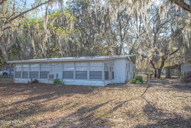 back of house featuring metal roof