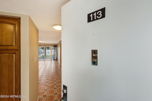 hallway with tile patterned floors