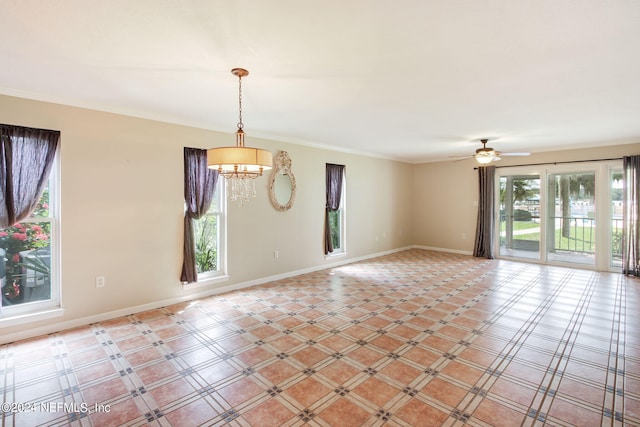 tiled spare room featuring ceiling fan with notable chandelier