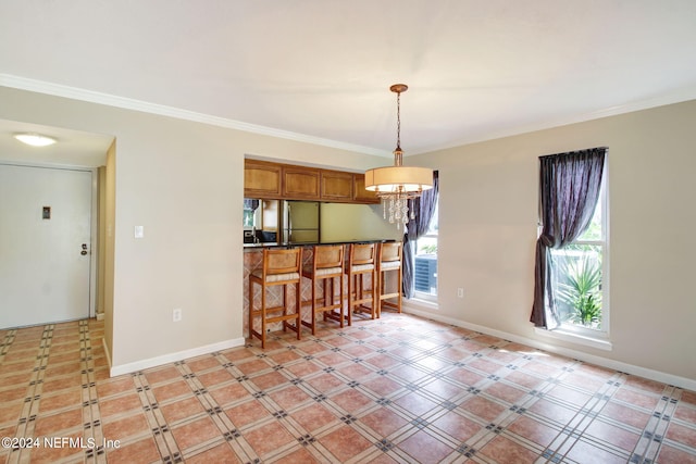 kitchen featuring light tile patterned flooring, an inviting chandelier, stainless steel refrigerator, and decorative light fixtures