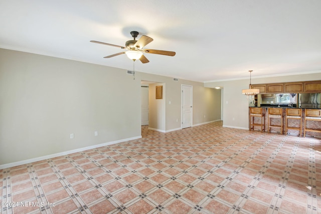 unfurnished living room featuring ceiling fan, visible vents, baseboards, and ornamental molding