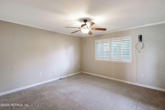 tiled spare room featuring ornamental molding and ceiling fan