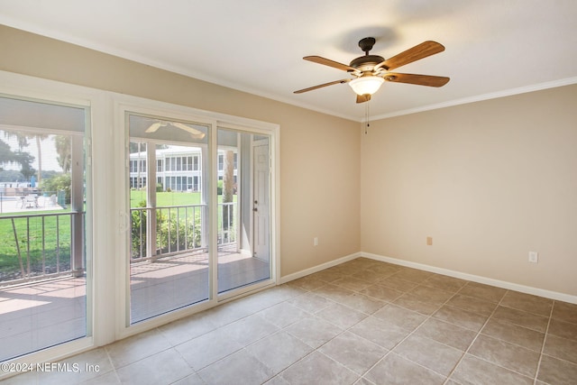 spare room with light tile patterned floors, baseboards, ornamental molding, and a ceiling fan