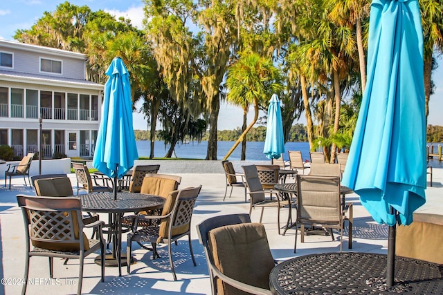 view of patio / terrace featuring a water view and outdoor dining area