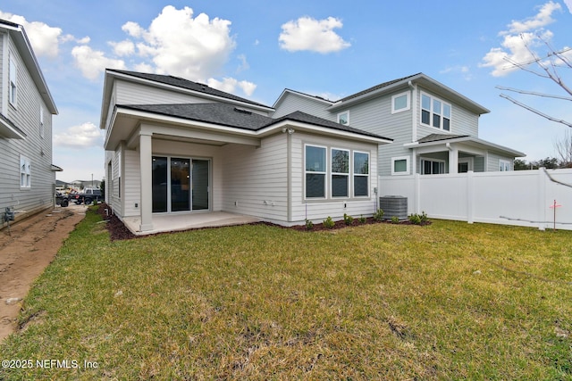 back of property featuring a patio area, central AC, and a yard