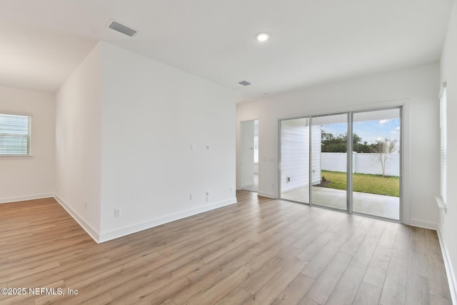 empty room with light hardwood / wood-style flooring