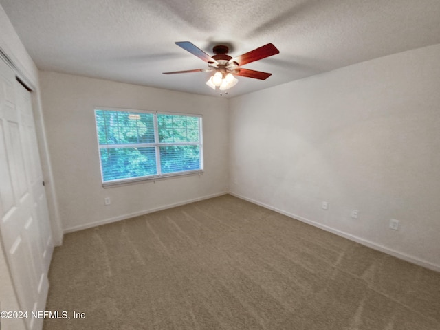 interior space featuring a textured ceiling and ceiling fan