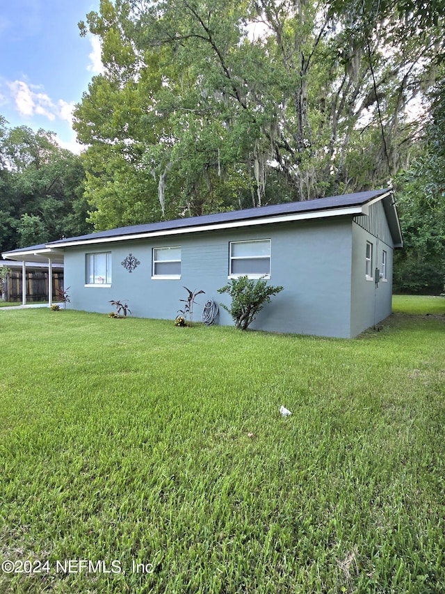 rear view of house with a lawn