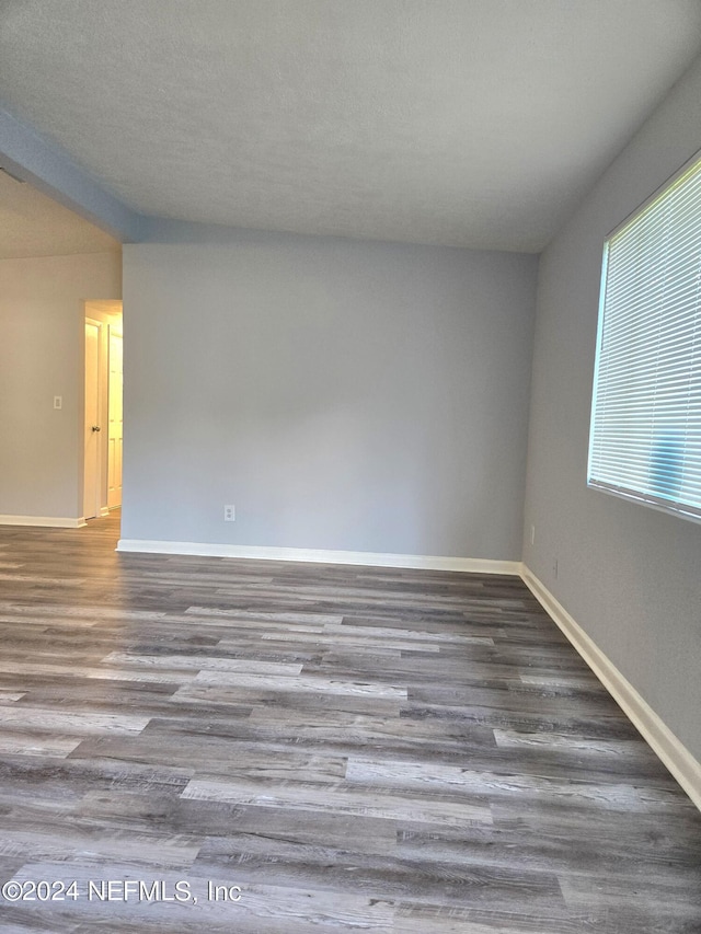 spare room with dark wood-type flooring