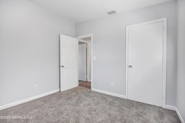 unfurnished bedroom with light colored carpet