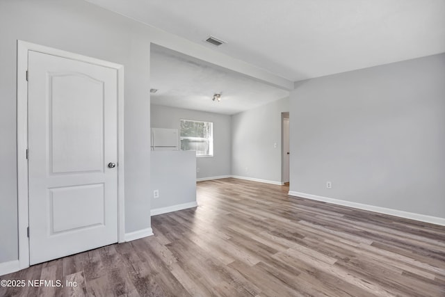 unfurnished room with light hardwood / wood-style flooring