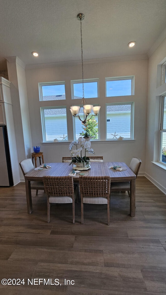 dining area featuring a chandelier, crown molding, and dark hardwood / wood-style floors