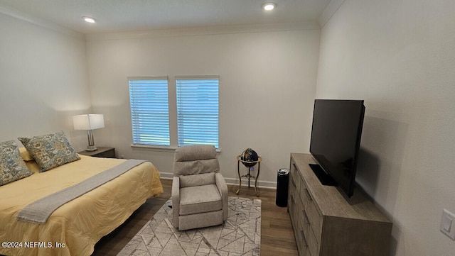 bedroom with ornamental molding and light hardwood / wood-style floors