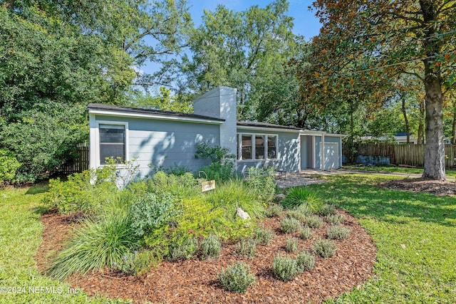 rear view of house with a yard