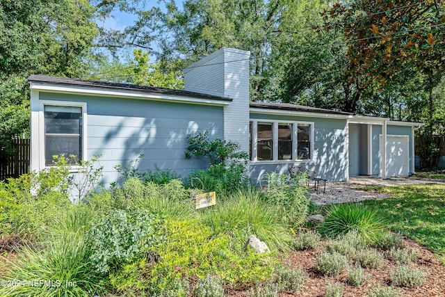 back of property with a garage