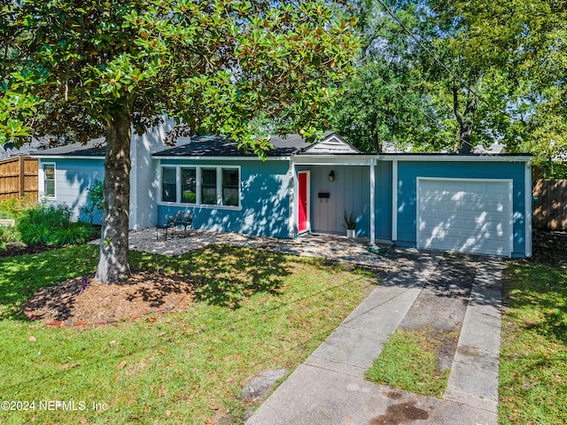 single story home featuring a garage and a front lawn