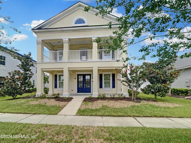 neoclassical / greek revival house featuring french doors, a front yard, a balcony, and covered porch