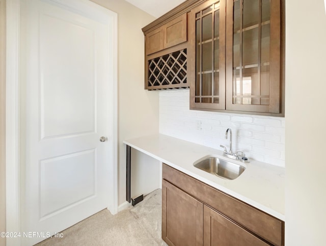 kitchen with light carpet, tasteful backsplash, and sink