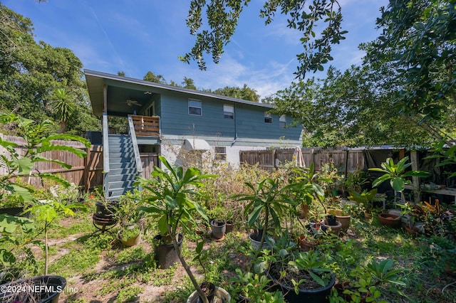 rear view of house featuring ceiling fan