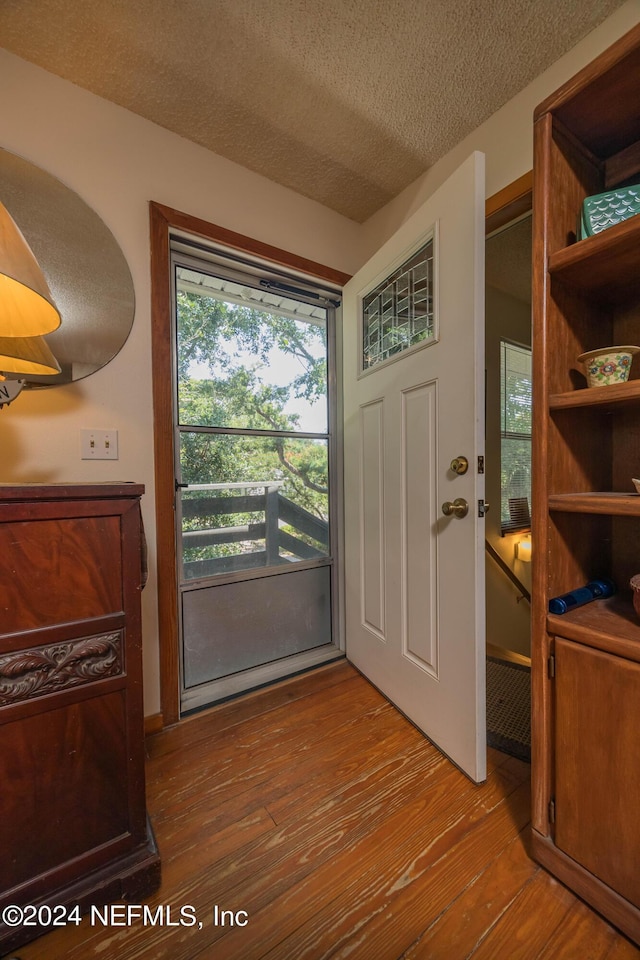 entryway featuring a textured ceiling and light hardwood / wood-style flooring