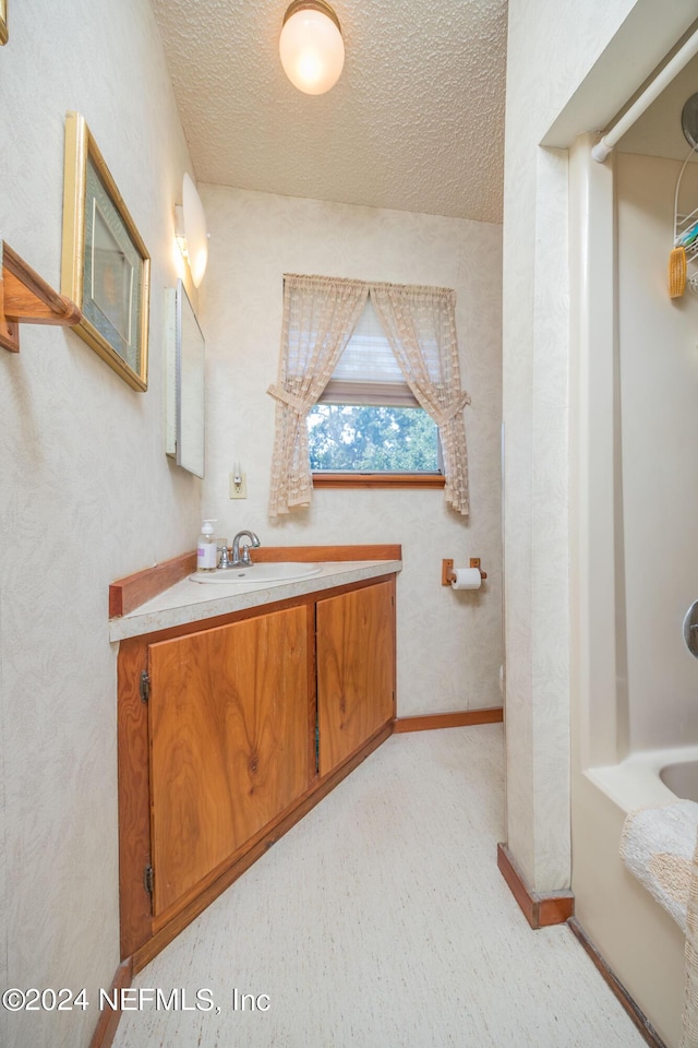 bathroom with vanity and a textured ceiling